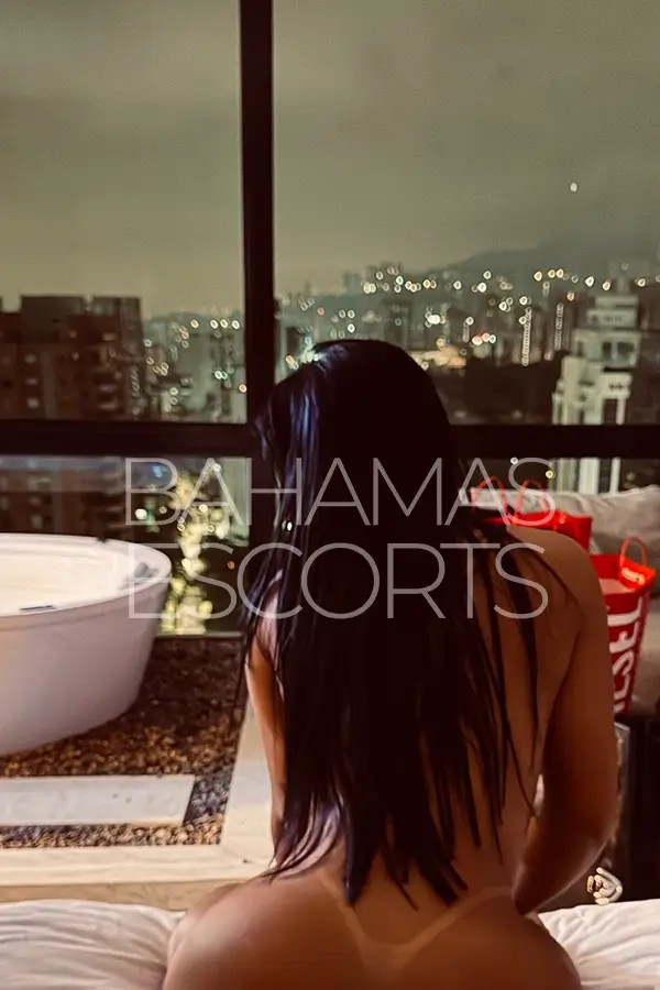 Attractive brunette relaxing in a modern penthouse with refined surroundings